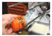  ??  ?? 15
Add a smear of engine oil to the rubber seal on a new oil filter, then fit and tighten it by hand onto the oil filter housing. Adding oil to the seal will reduce the risk of the seal catching and tearing when tightening the filter.