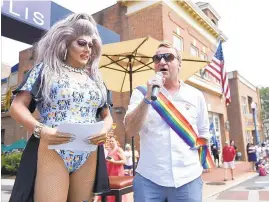  ?? STEVE RUARK/FOR THE CAPITAL ?? Annapolis Mayor Gavin Buckley, right, and Miss Troy, of Wilmington, Del., host of the Annapolis Pride parade, address parade-goers.