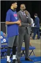  ??  ?? Delaware 87ers general manager Elton Brand, right, chats with former Sixer and current 87ers player Christian Wood at a recent game at the Bob Carpenter Center in Newark, Del.