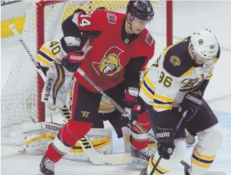  ?? AP PHOTO ?? KNOCK DOWN, DRAG OUT: Kevan Miller blocks a shot in front of the Senators’ Alexandre Burrows during the Bruins victory last night in Ottawa.