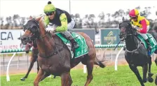  ?? Picture: AAP IMAGE ?? Jockey Jag Guthmann-Chester (left) rides Cabeirian to victory in race four on Saturday.