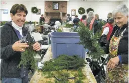  ?? BY SANDY ANTONY ?? Garden Club members Ann Wohlers (left) and Anne Stenner transform greens into beautiful wreaths, garlands, swags and tabletop arrangemen­ts.