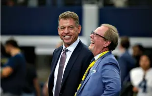  ?? Associated Press ?? ■ Broadcast personalit­y Troy Aikman, left, talks with sports reporter Ed Werder, right, before an NFL football game Sept. 8 between the New York Giants and Dallas Cowboys in Arlington, Texas.