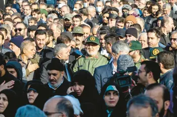  ?? ARASH KHAMOOSHI/THE NEW YORK TIMES ?? Gen. Hossein Salami, center, commander of Iran’s Revolution­ary Guard, attends a Jan. 22 funeral for Guard members killed in Syria. Iran has vowed revenge for another deadly attack in Syria last week.