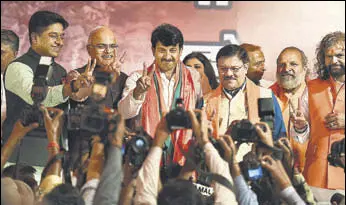  ?? RAJ K RAJ/HT PHOTO ?? Delhi BJP president Manoj Tiwari and other members of the party in a jubilant mood during a press conference at the party office in New Delhi on Wednesday.