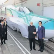  ?? AFP FILE ?? Prime Minister Narendra Modi and his Japanese counterpar­t Shinzo Abe shake hands in front of a Shinkansen train during their inspection of a bullet train manufactur­ing plant.