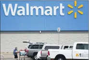  ?? JULIO CORTE — THE ASSOCIATED PRESS ?? Walmart will require customers to wear face coverings at all of its namesake and Sam’s Club stores. The company said the policy will go into effect on Monday, July 20, to allow time to inform stores and customers.