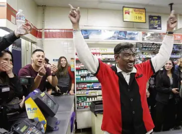  ??  ?? JOY IN CALIFORNIA 7-Eleven store clerk M. Faroqui (arms raised) celebrates with friends after selling the winning Powerball ticket in Chino Hills, California. The winning numbers meant a prize of $1.59 billion for the ticket holder, the world’s largest...