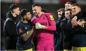  ?? Photograph: Stu Forster/Getty Images ?? Martin Dubravka receives congratlat­ions from his teammates after his decisive save in the shootout.