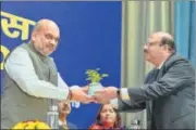  ?? PTI ?? Union home minister Amit Shah receives a sapling from NHRC general secretary Jaideep Govind in New Delhi on Saturday.