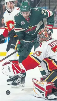  ?? ANTHONY SOUFFLE TRIBUNE NEWS SERVICE ?? Minnesota Wild’s J.T. Brown tries to put the puck past Calgary Flames goaltender David Rittich in the first period on Saturday.