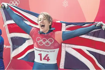  ??  ?? Great Britain’s Lizzy Yarnold celebrates winning gold in the Women’s Skeleton. PA.