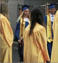  ?? GINGER RAE DUNBAR – DIGITAL FIRST MEDIA ?? Downingtow­n STEM Academy graduates walk into commenceme­nt on Thursday night.