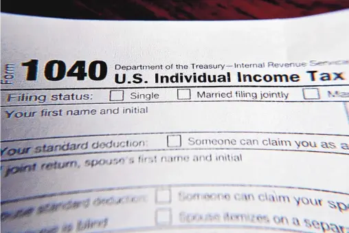  ?? KEITH SRAKOCIC/ASSOCIATED PRESS ?? Part of a 1040 federal tax form printed from the Internal Revenue Service website, in Zelienople, Pa. Tax filing season will start a bit later and look a bit different this year.