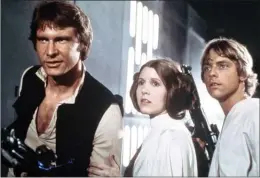  ?? The Associated Press ?? Harrison Ford, from left, Carrie Fisher and Mark Hamill are shown in a scene from the 1977 movie Star Wars. Fisher, who played Princess Leia in the original trilogy and the 2015 reboot, died Tuesday at the age of 60.