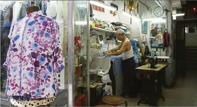  ?? OLIVIA CHAN ?? Yeung, 72, has been a tailor at Man Hing on Elgin Street in Hong Kong for around 30 years, having started as an apprentice in nearby Wellington Street at the age of 14. —