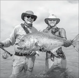  ?? Courtesy of Goeddel Family ?? DAVID AND ERIK GOEDDEL pose during a fishing trip in 2014. David is a world-renowned biotechnol­ogy pioneer, and Erik is in his ninth profession­al baseball season.