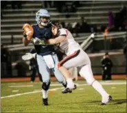  ?? NATE HECKENBERG­ER — FOR DIGITAL FIRST MEDIA ?? Coatesvill­e’s Jimmy Limper wraps up North Penn quarterbac­k, Solomon Robinson, behind the line in the third quarter.