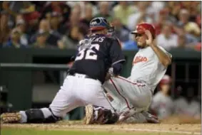  ?? NICK WASS — THE ASSOCIATED PRESS ?? The Phillies’ Nick Williams, right, is out at home on a tag by Nationals catcher Matt Wieters (32) during the seventh inning Friday in Washington.