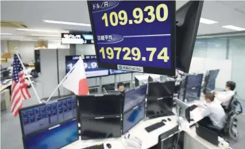  ?? — AFP ?? The yen rate against the US dollar (upper) and a share prices of the Tokyo Stock Exchange (bottom) are displayed at the dealing room of a foreign exchange brokerage in Tokyo on August 10, 2017.