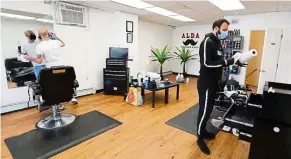  ?? — Photos: TNS ?? Elias Chalita and Hasan Halila preparing to open Alda barbershop in Quincy, Massachuse­tts, last Monday, by appointmen­t only.