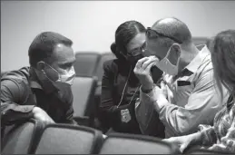  ?? JUAN FIGUEROA/ DALLAS MORNING NEWS ?? Fort Worth Police Department Detectives Jay Bennett, left, and Leah Wagner speak with Jim Walker after announcing the arrest of Glen Samuel McCurley on Tuesday in connection with the 1974 murder of Walker’s then-17-yearold sister Carla Walker.