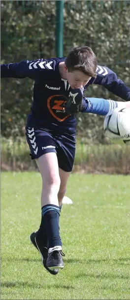  ??  ?? Ardee Cetic’s CJ Tighe gets a taste of Jamie Carr’s boot during their home game