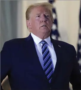  ?? ASSOCIATED PRESS ?? President Donald Trump stands on the balcony outside of the Blue Room as he returns to the White House Monday after leaving Walter Reed National Military Medical Center.