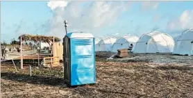  ?? JAKE STRANG ?? Amenities for patrons at the Fyre Fest on Exuma included tents and a portable toilet.