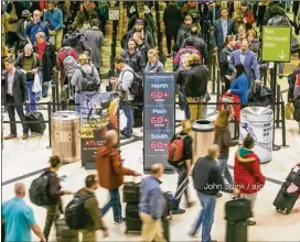  ?? JOHN SPINK / JSPINK@AJC.COM ?? Security lines at Hartsfield-Jackson Internatio­nal Airport stretched more than an hour long Monday morning. The airport’s general manager and U.S. Sen. Johnny Isakson are sounding the alarm as the shutdown drags on.