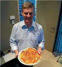  ??  ?? Bill English shows off a particular­ly disgusting-looking spaghetti pizza.