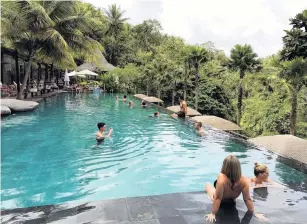  ??  ?? At the hotel Chapung Sebali, the Jungle Fish Bar is a draw for day trippers who want to spend a day hanging out at a pool in the tropical forest near Ubud. The hotel’s rooms, some with their own small swimming pools, are furnished in midcentury Danish style.