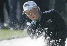  ?? Chris Carlson/Associated Press ?? Fred Couples hits from a bunker on the 17th hole Friday at the 81st Masters. Couples shot a 2-under 70 and finds himself on the leader board, 25 years after winning at Augusta National Golf Club.