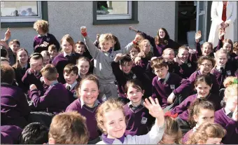  ?? by Michelle Cooper Galvin ?? Pupils celebrate at the opening the new Library at Gaelscoil Faithleann Killarney on Friday. Photo