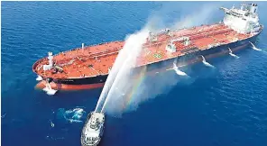  ??  ?? Top: The damaged Japanese tanker; footage of Iranian forces purportedl­y removing a mine; and the blazing Front Altair, above