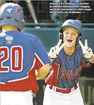  ?? AP ?? Jackson’s R.J. Vashey (l.) is greeted by Anthony Abbonizio after slugging one of his two homers in Little League World Series win on Monday.
