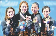  ??  ?? Pandelela (second right) celebrate with (from right) Cheong Jun Hoong, Leong MunYee and Nur Dhabitah Sabri after the prize presentati­on in Gold Coast, Australia on Wednesday.