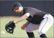  ?? Chris O'Meara / Associated Press ?? Second baseman Neil Walker fields a ground ball during drills at the MLBPA camp in Bradenton, Fla. on March 1. Walker signed with the Yankees on Monday.