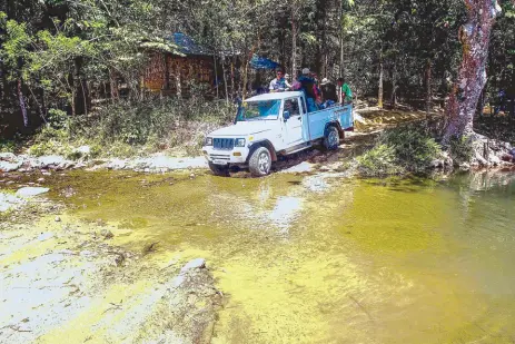  ??  ?? The Eagle Cement team travels to Sitio Bato on a 4x4. Part of their project includes road widening to increase accessibil­ity to the community.