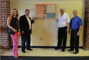  ?? SUBMITTED PHOTO ?? Erica Reilly, left, Chair of the Westtown Township Historical Society, Rustin Principal Dr. Mike Marano, David Walter, Westtown Township Historical Society, Robert Pingar, Westtown Township Manager display the Comission’s historical marker at Rustin High School.