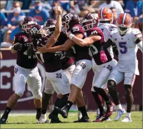  ?? (AP/Sam Craft) ?? Texas A&M place kicker Seth Small (second from left) reacts with teammates Saturday after kicking the game-winning field goal to give the No. 21 Aggies a 41-38 victory over the No. 4 Florida Gators in College Station, Texas.