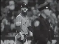  ?? The Associated Press ?? ORANGE PEELED: Houston starting pitcher Dallas Keuchel looks back after being taken out of the game during the fifth inning of the New York Yankees’ 5-0 victory Wednesday. Three straight wins at Yankee Stadium give New York a 3-2 lead in the...