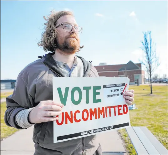  ?? Paul Sancya
The Associated Press ?? A man holds a “Vote Uncommitte­d” sign in Dearborn outside a voting location for the Michigan primary election last week, urging people to protest the Biden administra­tion’s support for Israel in its war against Hamas terrorists.