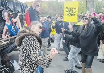  ?? GRAHAM HUGHES, THE CANADIAN PRESS ?? People dance while taking part in a protest in support of a return to dancing in venues in Montreal. Quebec and British Columbia are the only two provinces that continue to ban dancing in bars and nightclubs as part of their COVID-19 regulation­s.