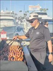 ?? TOM BRAY — STAFF ?? The crew from Naples Rib Company serves food at the Big Bang on the Bay event in Long Beach on Saturday.
