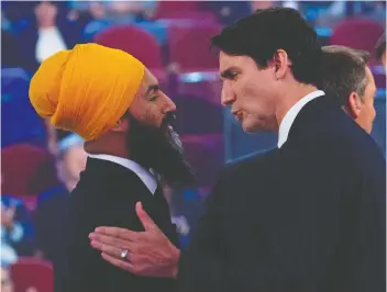  ?? ADRIAN WyLD ?? Prime Minister Justin Trudeau and NDP Leader Jagmeet Singh chat following a debate Oct. 10, B.C.’s NDP government believes the minority government status of Trudeau will encourage him to work with Singh.