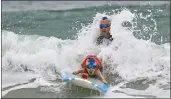  ?? JEFF GRITCHEN — SOUTHERN CALIFORNIA NEWS GROUP ?? Kioni “Kentucky” Gallahue and his goldendood­le Derby from San Diego compete in the Purina Pro Plan Incredible Dog Challenge surf competitio­n in Huntington Beach on Friday.