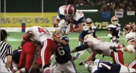  ?? ITSUO INOUYE — THE ASSOCIATED PRESS FILE ?? In this file photo, East’s Kevin Turner, of Alabama, dives over the top for a touchdown in the fourth quarter of the Japan Bowl, the American collegiate all-star football game, at the Tokyo Dome. A fullback at Alabama before playing eight years in the...