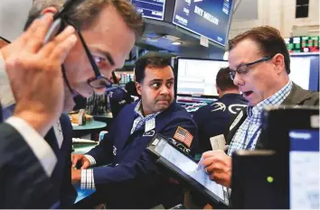  ?? AP ?? Traders at the New York Stock Exchange. US President Donald Trump has predicted the US market could ‘go up dramatical­ly’ once trade deals were renegotiat­ed.