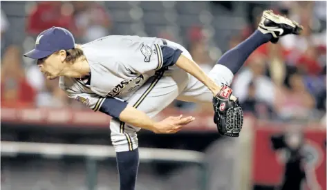  ?? THE ASSOCIATED PRESS FILES ?? John Axford pitches for the Milwaukee Brewers in June 2010. The nine- year veteran from Simcoe, Ont., is at Blue Jays spring training hoping to earn a spot with the big club after signing a minor- league deal last week.